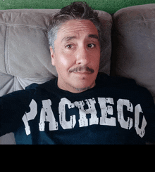 a man wearing a black shirt with the word pacheco on it