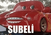 a red car with googly eyes and the word subeli written on it