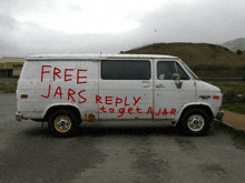 a white van has the words free jars reply to get a jar written on the side