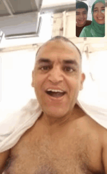 a man without a shirt is on a video call with two people