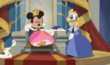 mickey mouse is sitting on a throne next to a duck