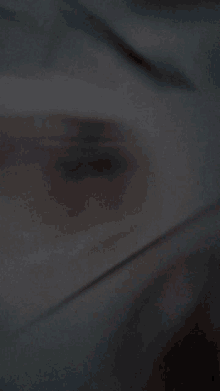 a blurred image of a person 's face with a red eye