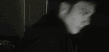 a blurry picture of a person 's face in the dark