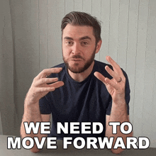 a man with a beard and a ring on his finger says we need to move forward