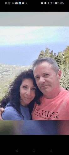 a man and a woman are posing for a picture and the man is wearing a shirt that says ' hawaii '