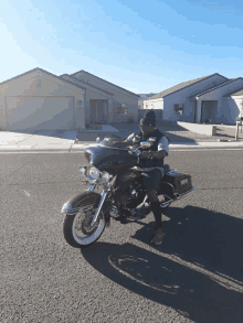 a man is riding a harley davidson motorcycle on the street