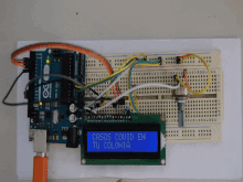 a arduino board is connected to a display that says casos covid en tu colonia