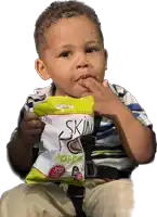 a young boy holds a bag of skin popcorn