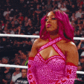 a woman with pink hair is wearing a pink leopard print dress and gloves