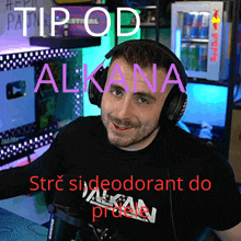 a man wearing headphones and a black shirt that says tip pod alkana