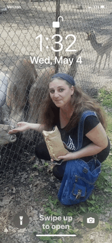 a phone screen shows a woman feeding a donkey on a wed may 4th