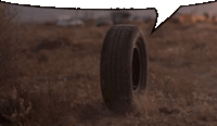 a tire is laying on the ground with a speech bubble above it