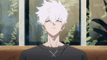 a man with white hair is sitting in front of a window with bilibili written in the corner