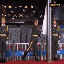 a man in a military uniform holds a flag in front of a sign that says ' beijing 2022 '