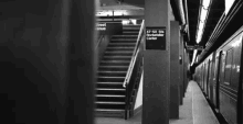 a black and white photo of a subway station with stairs and a sign that says ' recreation center '