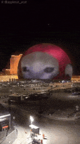 a large sphere with a picture of a face projected onto it