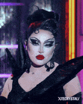 a drag queen with xtecrystali written on the bottom of the image