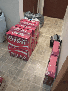 a bunch of coca cola boxes are stacked on the floor