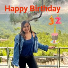 a woman in a denim jacket stands in front of a mountain with the words happy birthday 32 written above her