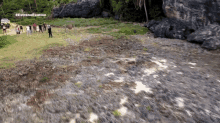 an aerial view of a group of people standing on a rocky hillside with the words estreno exation written on the bottom