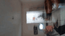 a blurry picture of a person standing in a kitchen