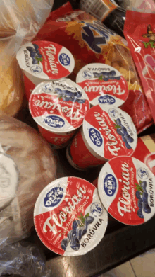 several cups of florian borůvka yogurt sit on a table