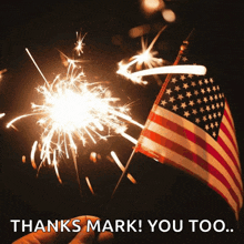 a hand holding a sparkler in front of an american flag with the words " thanks mark you too " below it