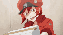 a girl in a red hat is holding a cardboard box and smiling