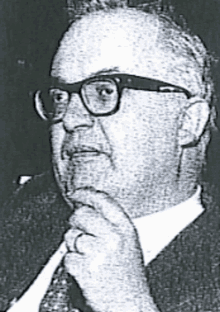 a black and white photo of a man with glasses