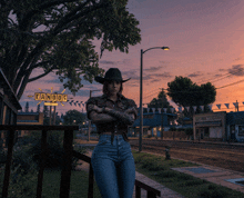 a woman in a cowboy hat stands in front of a sign that says bandog