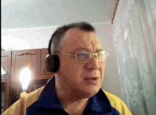 a man wearing headphones and glasses is talking