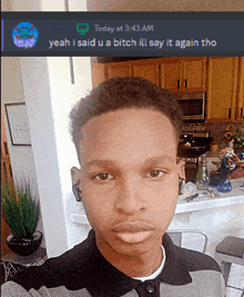 a young man taking a selfie in a kitchen with a chris message