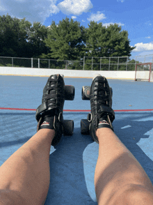 a person wearing roller skates on a blue carpet