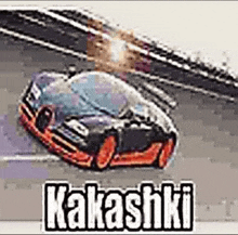 a toy car is driving down a race track with the words kakashi on it .