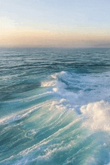 aerial view of a large body of water with waves crashing on the shore .