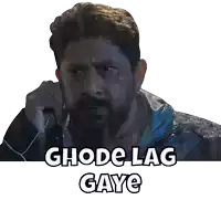 a man with a beard is talking on a cell phone with the words ghode lag gaye above him