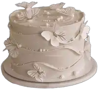 white cake with butterflies and pearls on it