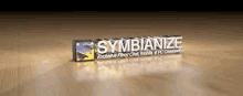 a 3d rendering of a symbianize logo on a wooden floor .