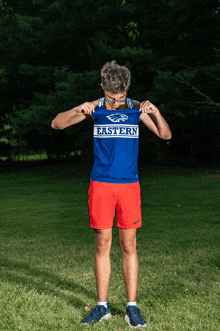 a man wearing a blue shirt that says eastern on the front