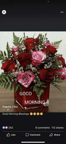 a bouquet of red and pink roses in a red vase with a good morning message