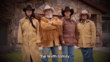 a group of people standing in front of a stone building with the words " the wirth family " on the bottom