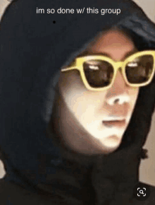 a person wearing sunglasses and a hoodie with the words im so done w / this group written on the bottom