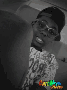 a boy wearing glasses and a hat with camwow retro on the bottom right