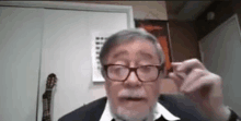 an older man with glasses and a mustache is talking on a video call .