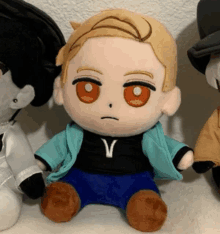 a stuffed doll with a letter v on his shirt