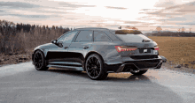 an audi rs6 is parked on the side of the road