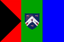 a green red and blue flag with a coat of arms