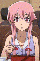 a girl with pink hair is sitting at a table eating something with a spoon