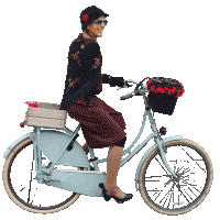 a woman is riding a bike with a basket on the front