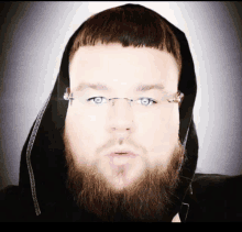 a man with glasses and a beard is wearing a black hoodie